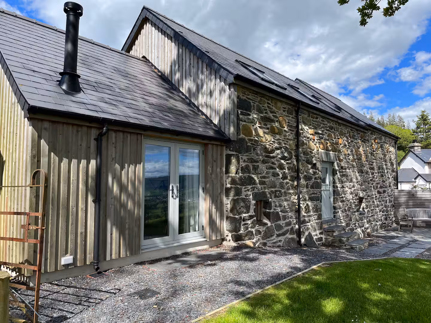 The Barn from the rear — open valley views beyond the stone walls