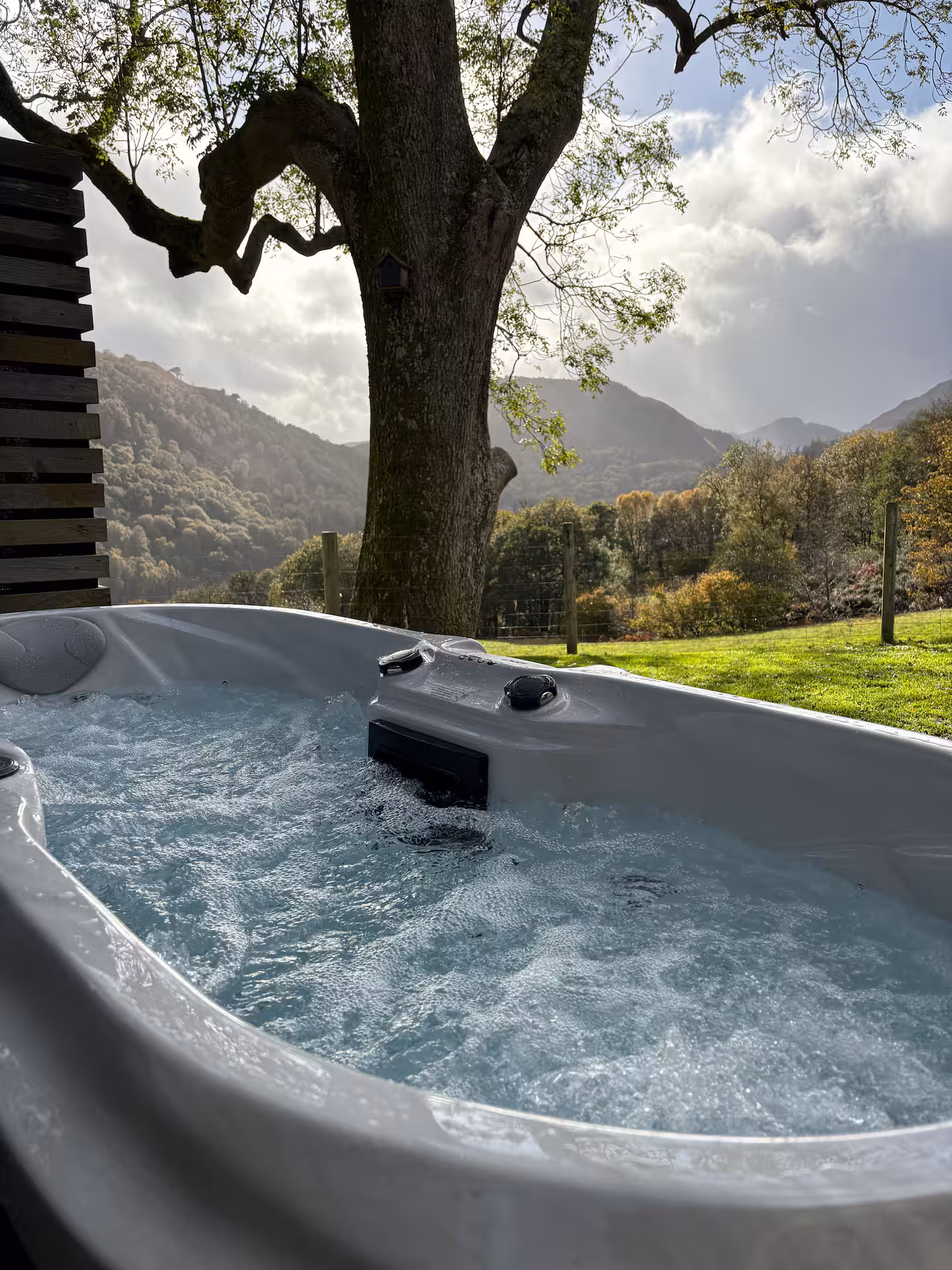 The Bothy's hot tub looking across the fields to the hills