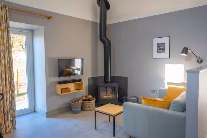 Wood-burning stove in the open-plan lounge at The Bothy