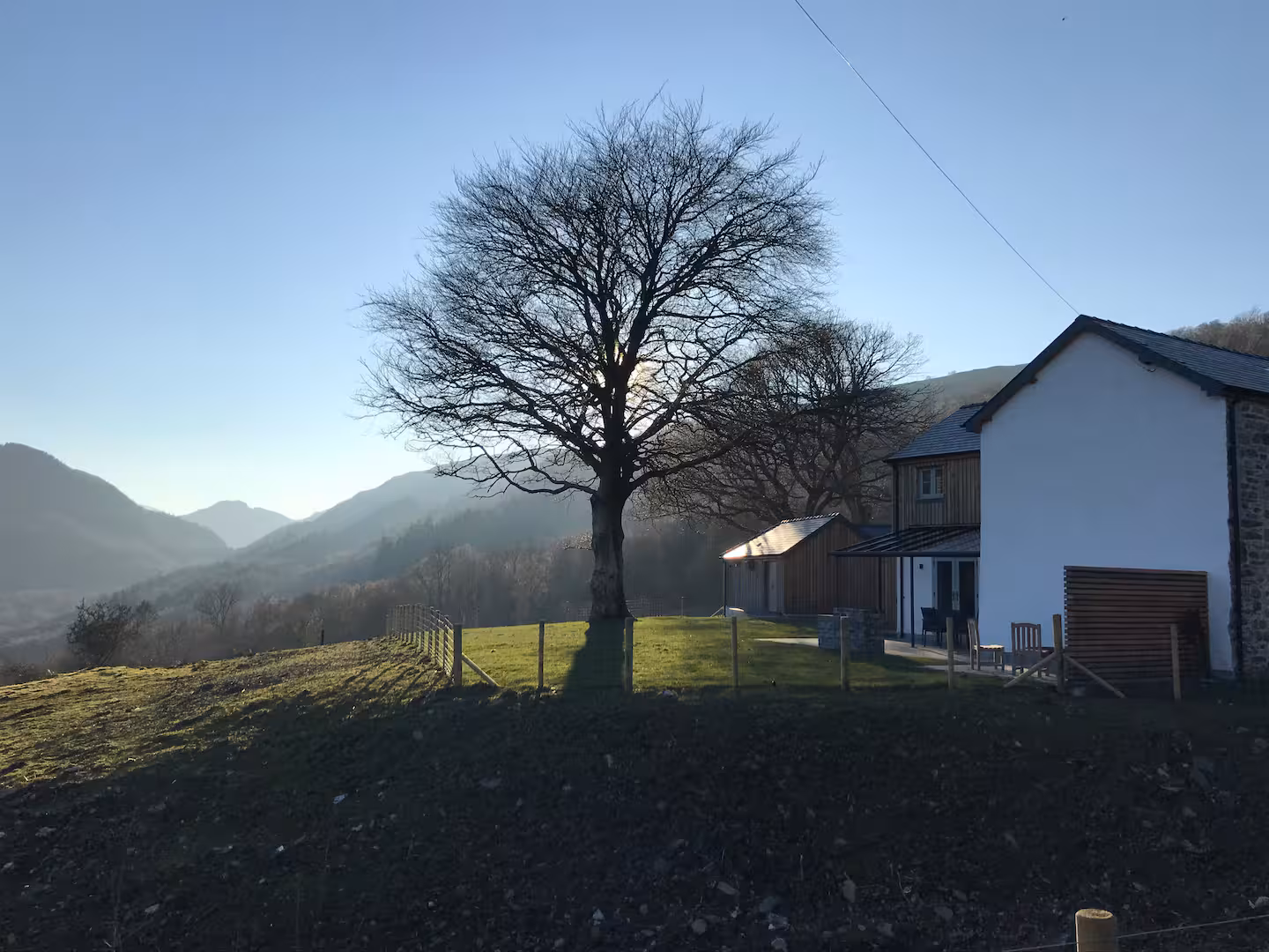 The Farmhouse with the ancient tree and Snowdonia mountains behind