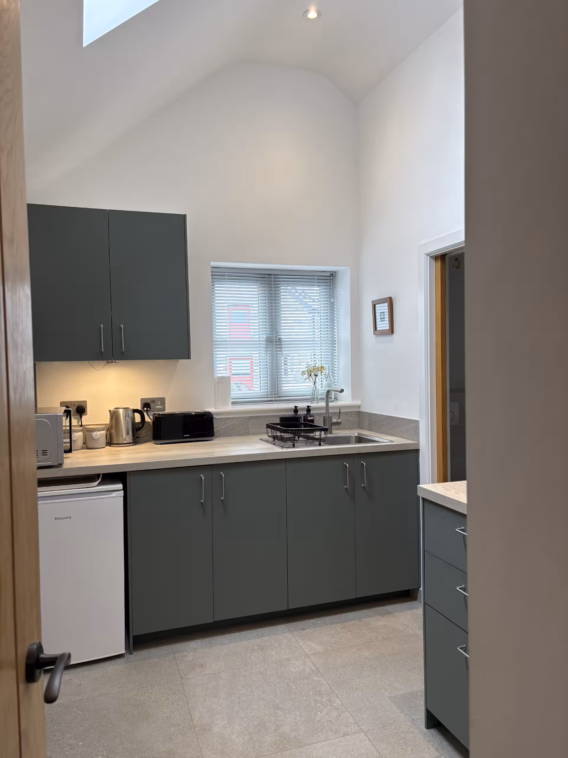 Compact kitchen at The Wheelhouse with induction hob and folding dining table