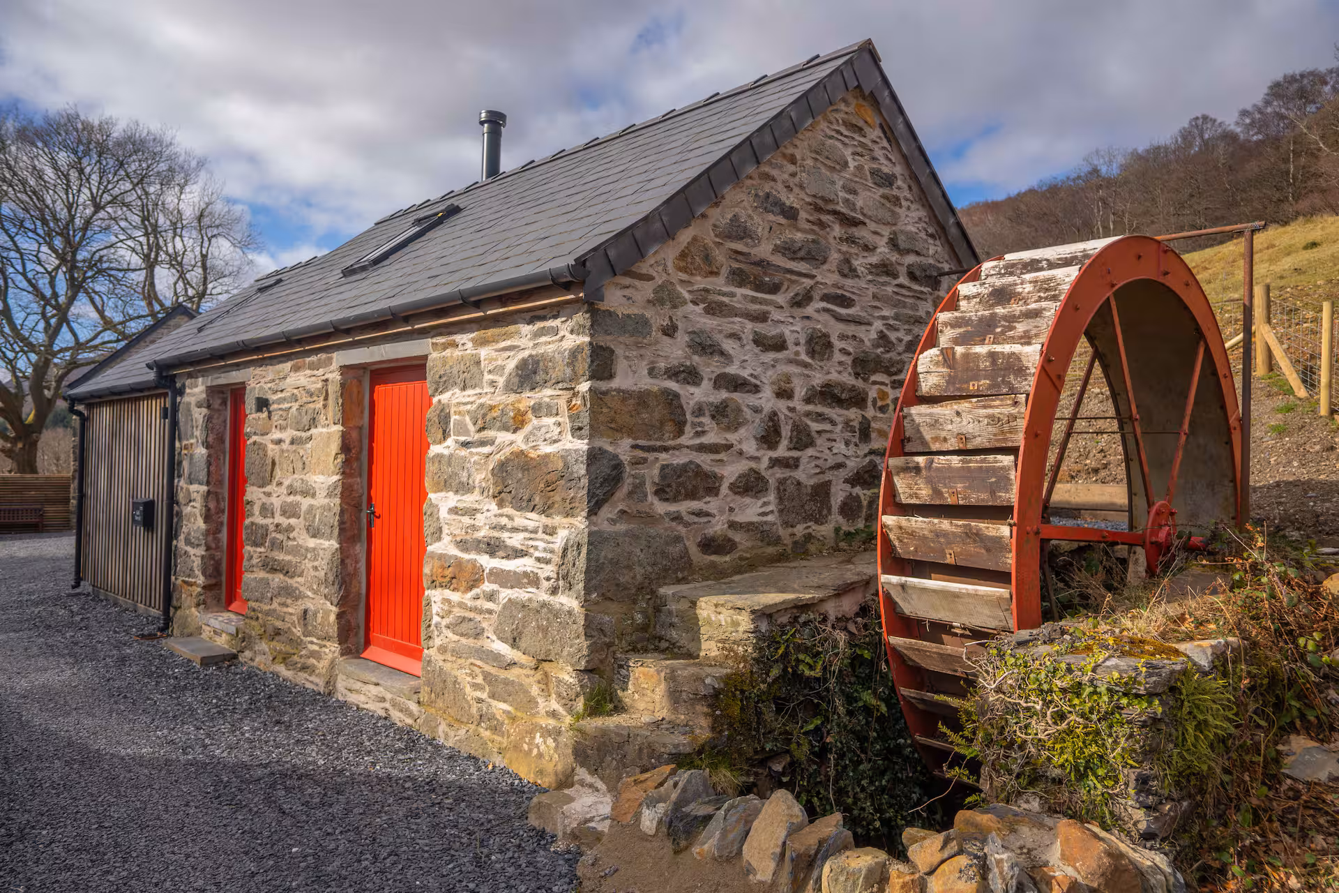 The Wheelhouse — converted watermill cottage with original wheel still in place